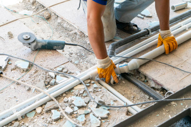 Plumber laying plumbing at construction site
